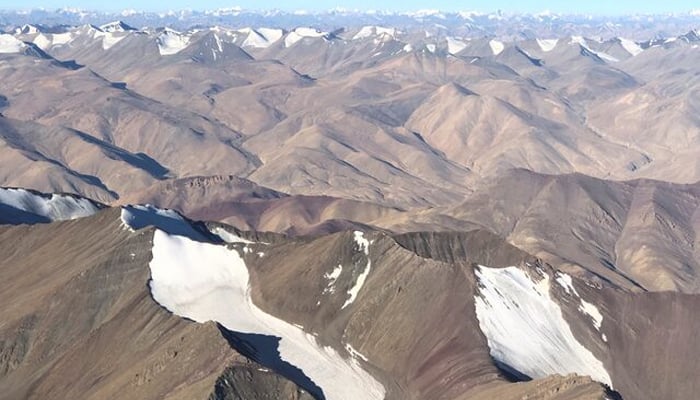 The snow-covered mountain range is seen from a passenger plane in the Ladakh region on September 14, 2020. – Reuters