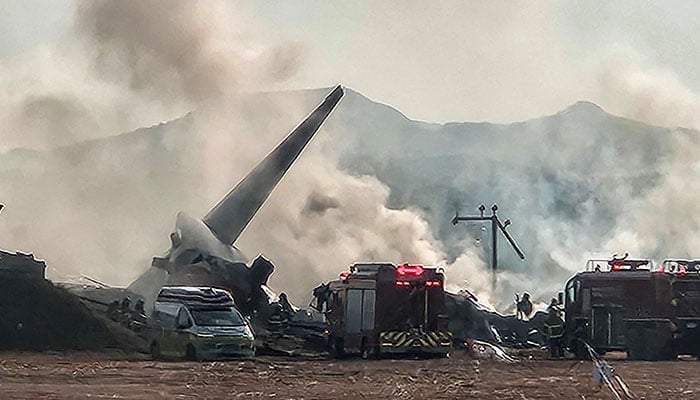 Firefighters carry out firefighting operations on a plane that skidded off the runway at Muan International Airport in Muan, South Jeolla province, South Korea, on December 29, 2024. – Reuters