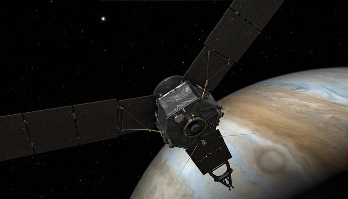 An artist's rendering of NASA's Juno spacecraft at Jupiter, with solar panels and main antenna facing the sun and Earth. —NASA/Archive