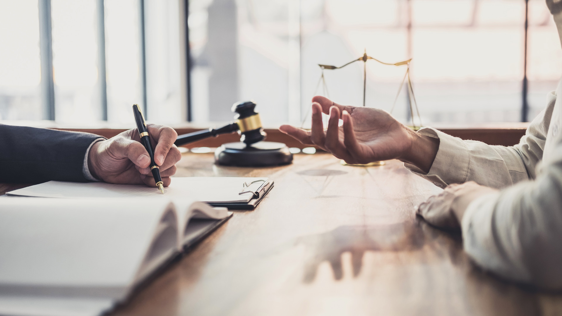 Two people who have a legal discussion in an office