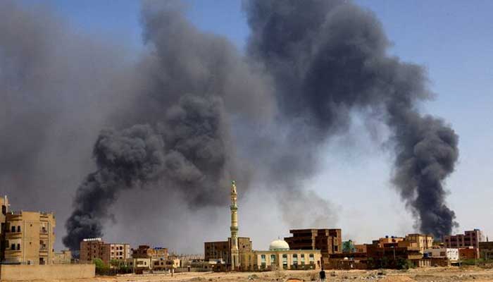 The smoke rises above the buildings after aerial bombard