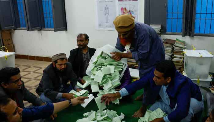 Voting officers tell the voting documents during the general elections in Karachi, on February 8, 2024. - Reuters