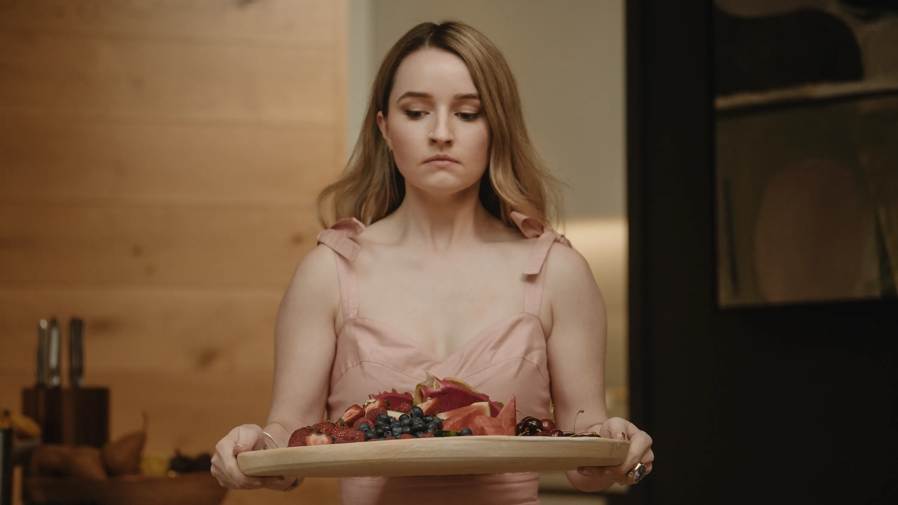 Kaitlyn dever holding a plate of apple cider vinegar