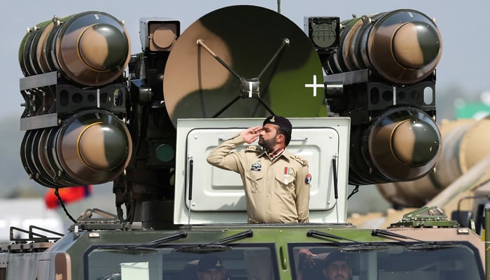 The Pakistani army soldier greets while standing in an air defense missile system during the Pakistan military parade in Islamabad, Pakistan, March 23, 2022. - Reuters