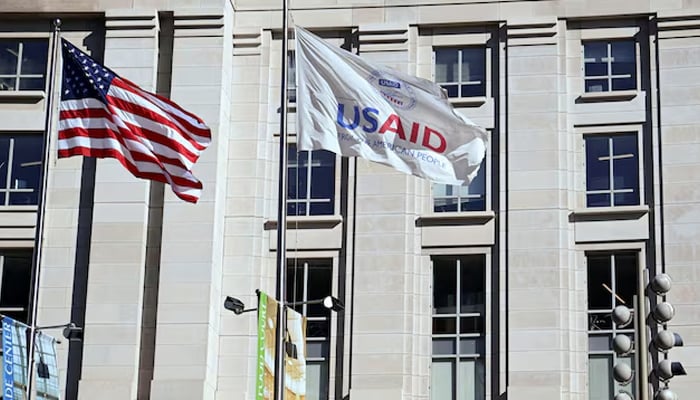 An American flag and a USAID flag flies outside the USAID building in Washington, DC, USA, February 1, 2025. - Reuters