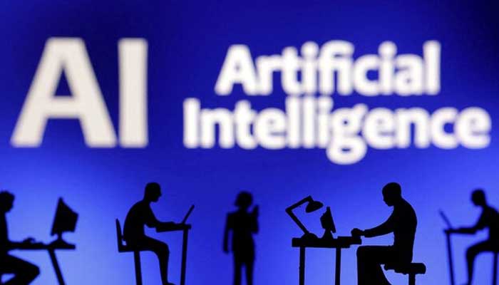 The figures with computers and smartphones are seen in front of the words artificial intelligence AI in this illustration taken, February 19, 2024. - Reuters