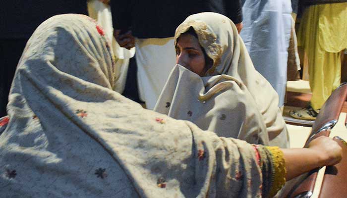 Passengers who were rescued from a train after he was attacked by militants, sit at the railway station in Quetta, Baluchistan, on March 12, 2025. - Reuters 