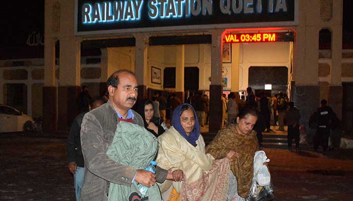 Passengers who were rescued from a train after he was attacked by militants, walk with their belongings at the railway station in Quetta, Baluchistan, March 12, 2025. - Reuters 