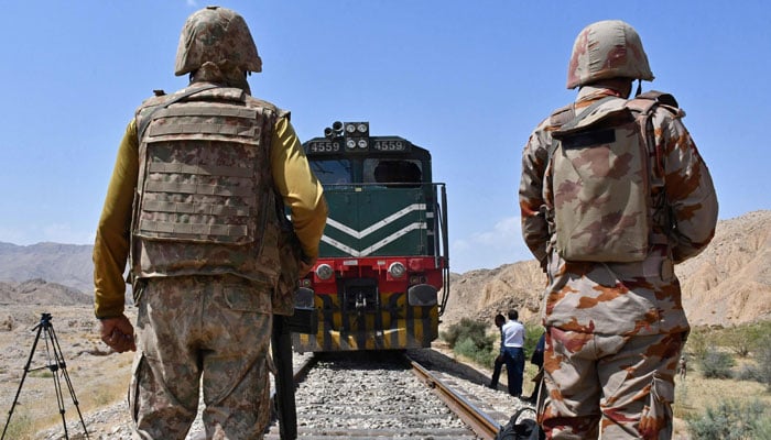 The border body soldiers remain guard at the siege site after the terrorists ambushed a train in the remote mountainous area, in Pehro Kunri in Baluchistan on March 15, 2025. - AFP