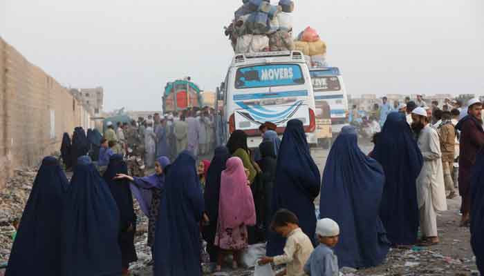 Afghan people meet the Board's buses while preparing to return home, after Pakistan gave the last warning to undocumented migrants to leave, at a bus stop in Karachi, Pakistan, on October 29. - Reuters