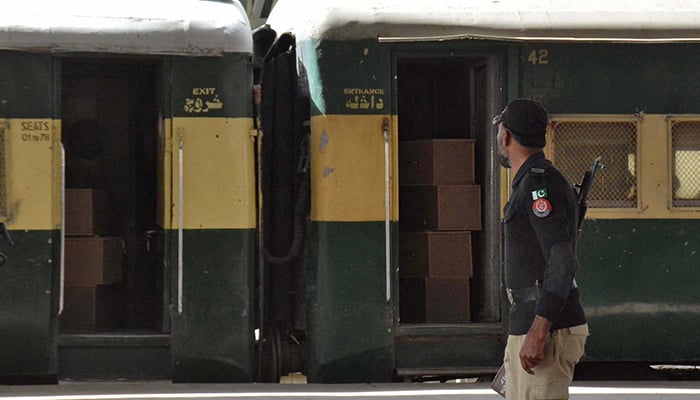 A member of the security force personnel is stored near a train that contains empty coffins that are sent to Bolan, where a passenger train was attacked by separatist militants, in a railway station in Quetta, on March 12, 2025. - Reuters.