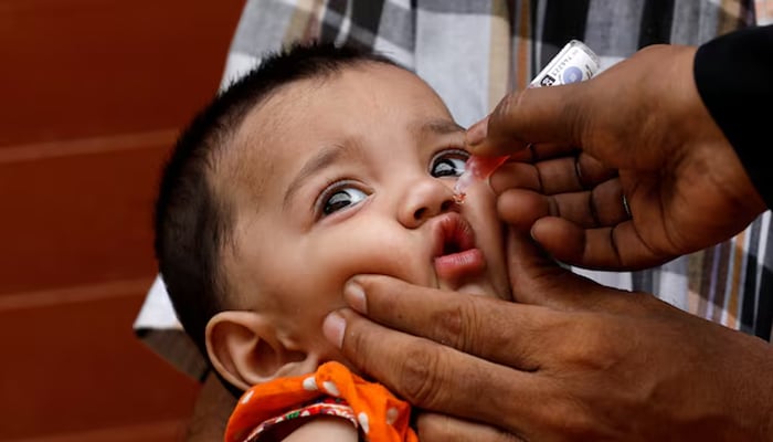 A girl receives drops of polyomyelitis vaccine, during an anti-political campaign, in a low-income neighborhood in Karachi, on July 20, 2020.-Reuters