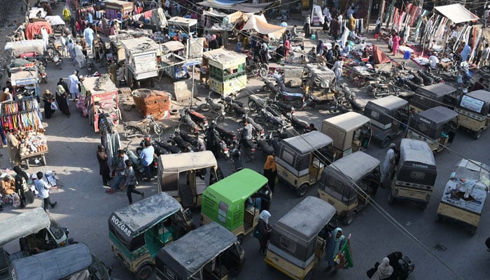 Rickshshaws is parked in the Karachis Karimabad market on March 5, 2025. - Online