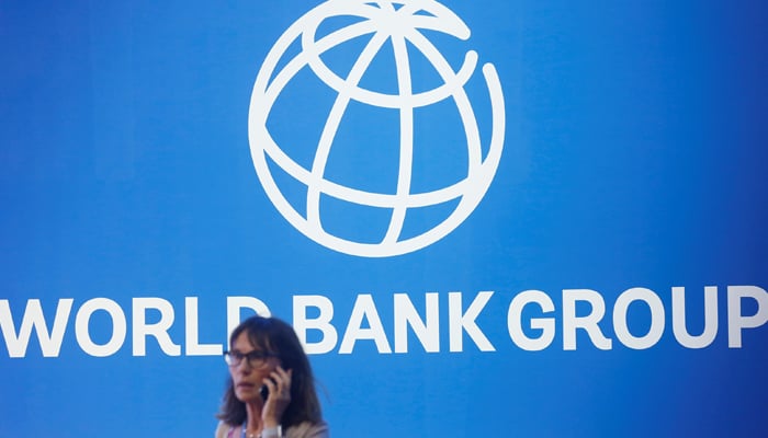 A participant is near a World Bank logo in the International Monetary Fund - Annual World Bank 2018 meeting in Nusa Dua, Bali, Indonesia, October 12, 2018. - Reuters