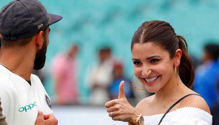 The captain of India, Virat Kohli, looks at his wife Anushka Sharma while celebrating with his teammates after winning the test series at the Sydney Crick Ground - AFP