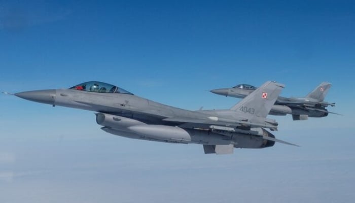F-16 aircraft fly during a NATO multimedia event on an air base in Malbork, Poland, March 21, 2023.-Reuters