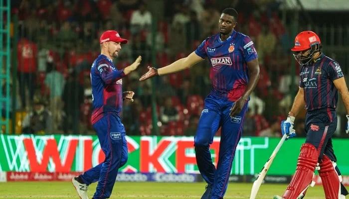 Islamabad Uniteds Jason Holder (Center) celebrates with Colin Munro after saying goodbye to Karachi Kings Aamir Jamal (right) during his PSL 10 match at the National Bank Stadium in Karachi on April 20, 2025. - PCB