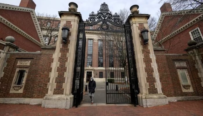 A person walks through Harvard Yard at Harvard University in Cambridge, Massachusetts, USA, December 7, 2023. - Reuters