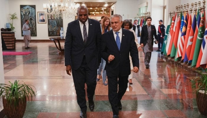British Foreign Secretary David Lammy (left) and Vice Prime Minister Ishaq walk together during an event in Islamabad on May 16, 2025. - High British Commission in Islamabad