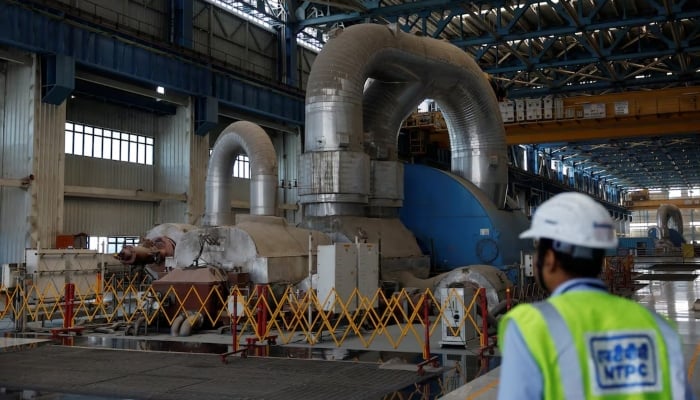 An employee is seen within the NTPC power station (National Thermal Power Corporation) in Olapur, India, March 2, 2025. - Reuters