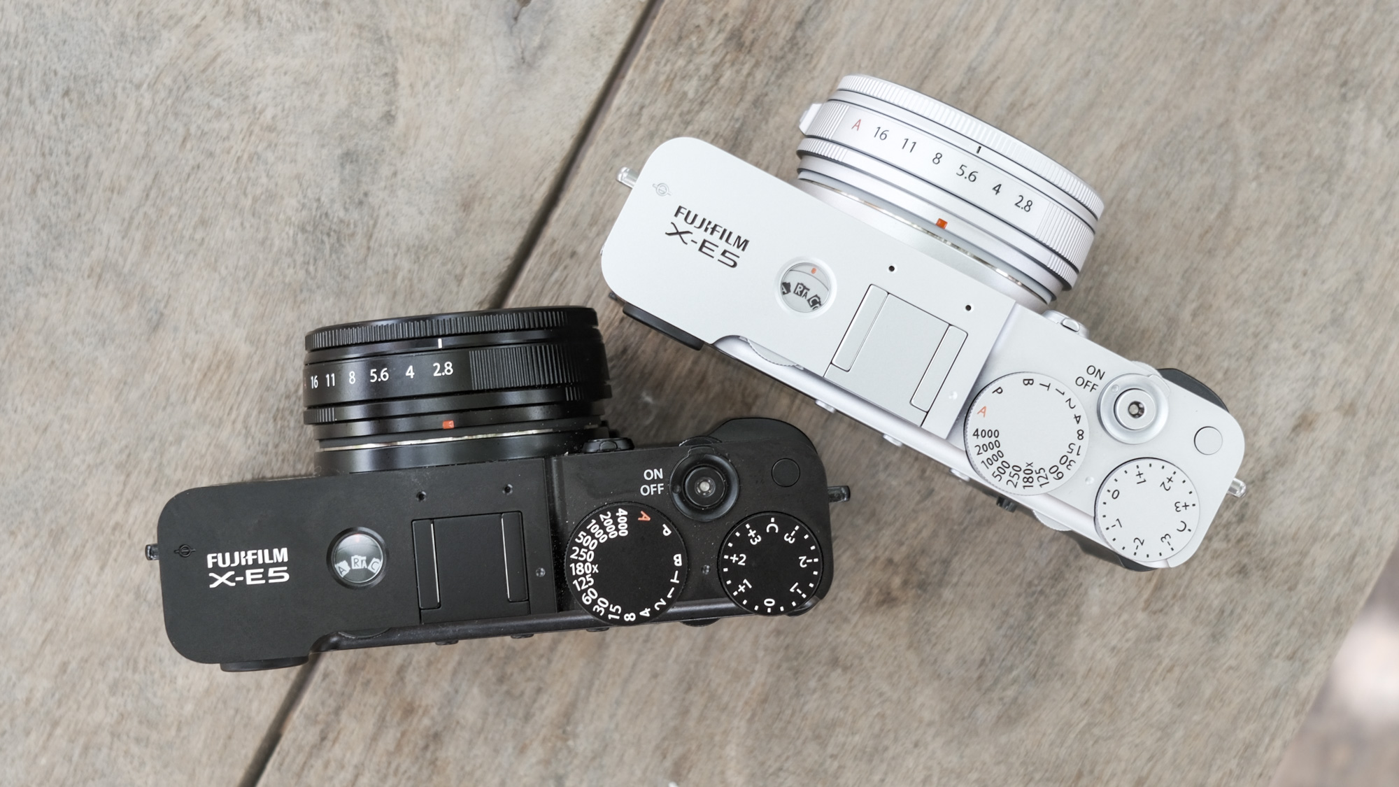 Up to the back of all Black Fujifilm X-E5 along with Silver Fujifilm X-E5, in a wooden bank