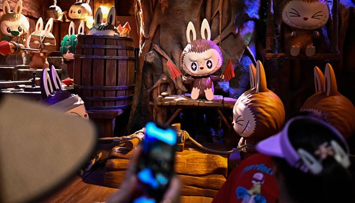The character Labubu in an exhibition hall while people visit Pop Mart Pop Land in Beijing, China, on June 18, 2025. - AFP