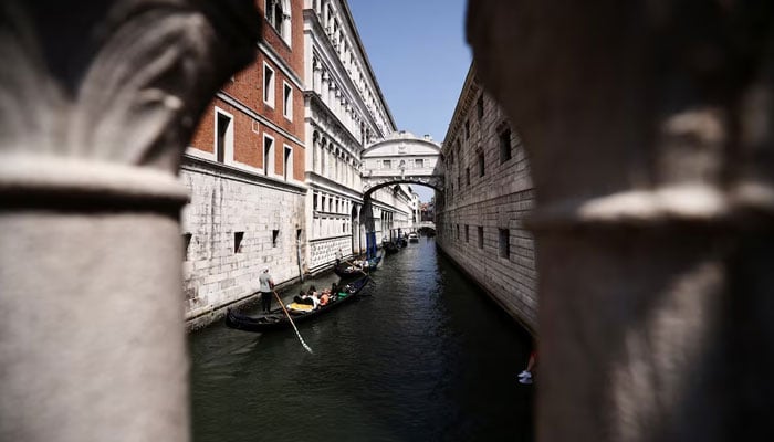 The Gondoleros travel in their gondolas through the Venice Canal before the expected wedding of the founder of Amazon Jeff Bezos and Lauren Sánchez, in Venice, Italy, June 22, 2025. - Reuters