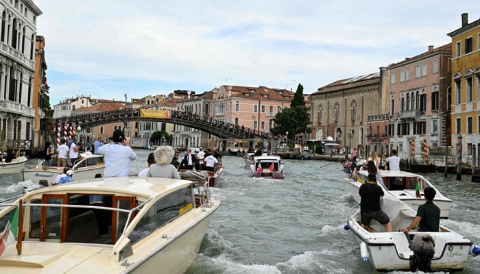 The founder of Amazons de Boat Moa, Jeff Bezos, is escorted in the Grand Canal on his wedding day in Venice on June 27, 2025. - AFP