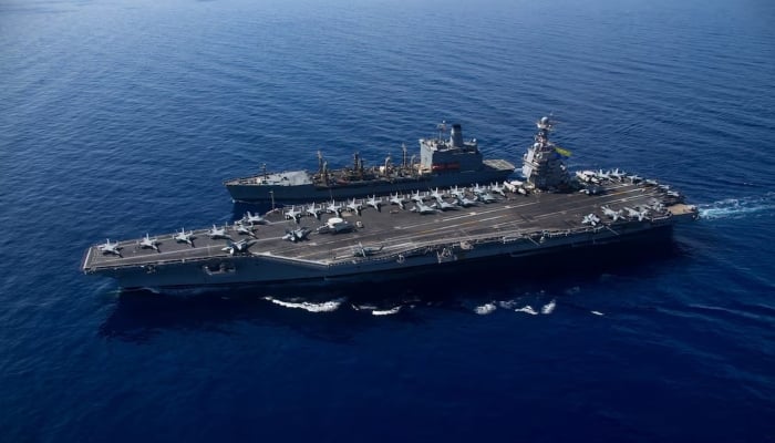 The largest aircraft carrier USS Gerald R Ford vape along with the USNS Laramie (T-AO-203) during a fuel in the sea in the Eastern Mediterranean Sea, in this photo taken on October 11, 2023.-Reuters