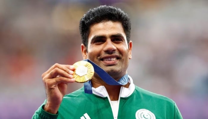 Pakistan's Gold Medalist Arshad Nadeem celebrates at the Paris 2024 Olympic Games with his podium medal - Reuters