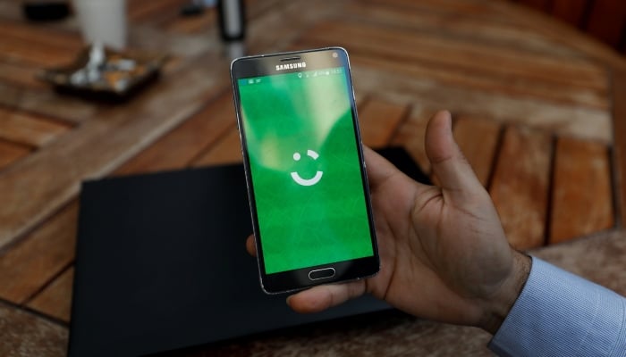 The image shows the logo of the Careem transport company on a mobile phone. - Reuters