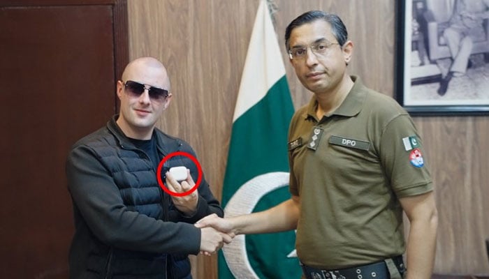 The influencer of British social networks Miles Routledge, also known as Lord Miles, shakes hand with a Jhelum police dpo in this image without date. - x/@real_lord_miles