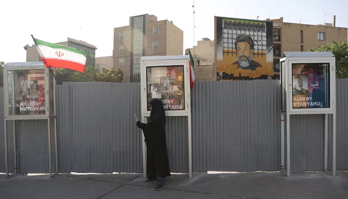 A woman is in a street, in the middle of the conflict in Iran-Israel, in Tehran, Iran, June 23, 2025.-Reuters