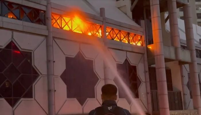 You can see a fire in a shopping center in Rashid Minhas Road in Karachi, June 18, 2025. - Screengrab through PakGazette News