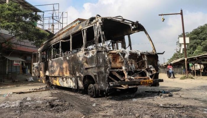 A picture of the burned bus after violence broke out in the streets of Manipur, India. - AFP/file