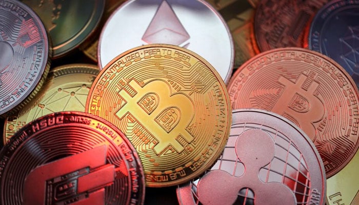 This image of illustration shows representations of cryptocurrencies, including Bitcoin, Dash, Ethereum, Ripple and Litecoin, taken on June 2, 2021.