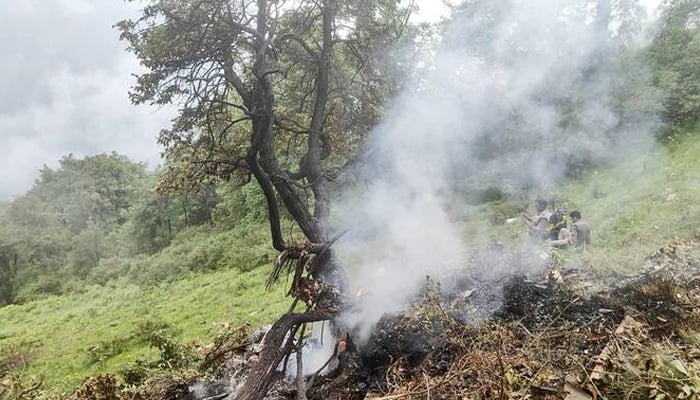 This booklet photography taken on June 15, 2025 and published by the State Force for Disaster Response (SDRF) of Uttarakhand Indies, the state shows the smoke that is eliminated from the site of a helicopter clash near Gaurikund. - Reuters