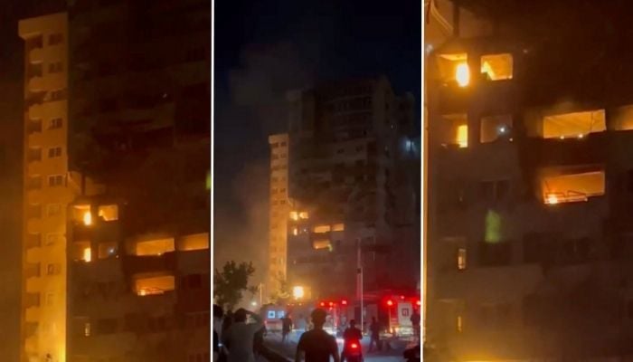 People see how the fire burns in a damaged building in an Israeli strike in Tehran, Iran, on this screen obtained from a video of social networks released on July 13, 2025. - Reuters