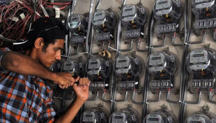 An image that shows an electrician who works in an electricity meter. - AFP/file