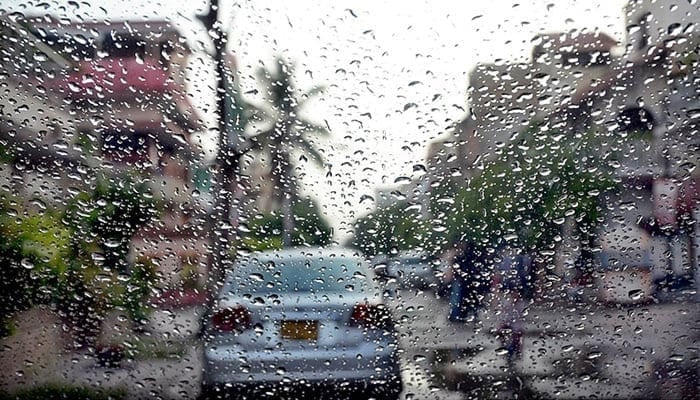 A car seen through a windshield with rain drops. - App/file