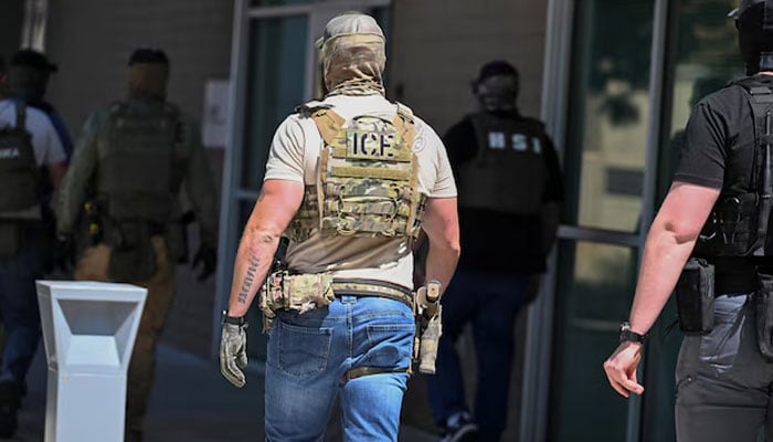 The masked law agents, including HSI and ICE agents, enter an immigration court in Phoenix, Arizona, USA, May 21, 2025. - Reuters