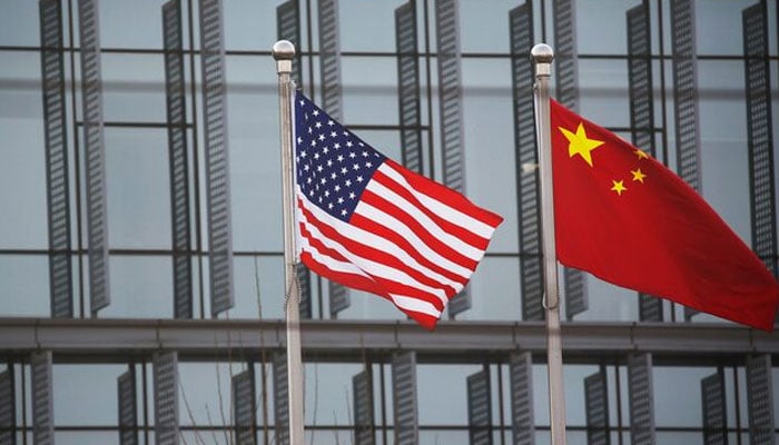 The Chinese and American flags flutter outside the construction of an American company in Beijing, China, January 21, 2021. - Reuters
