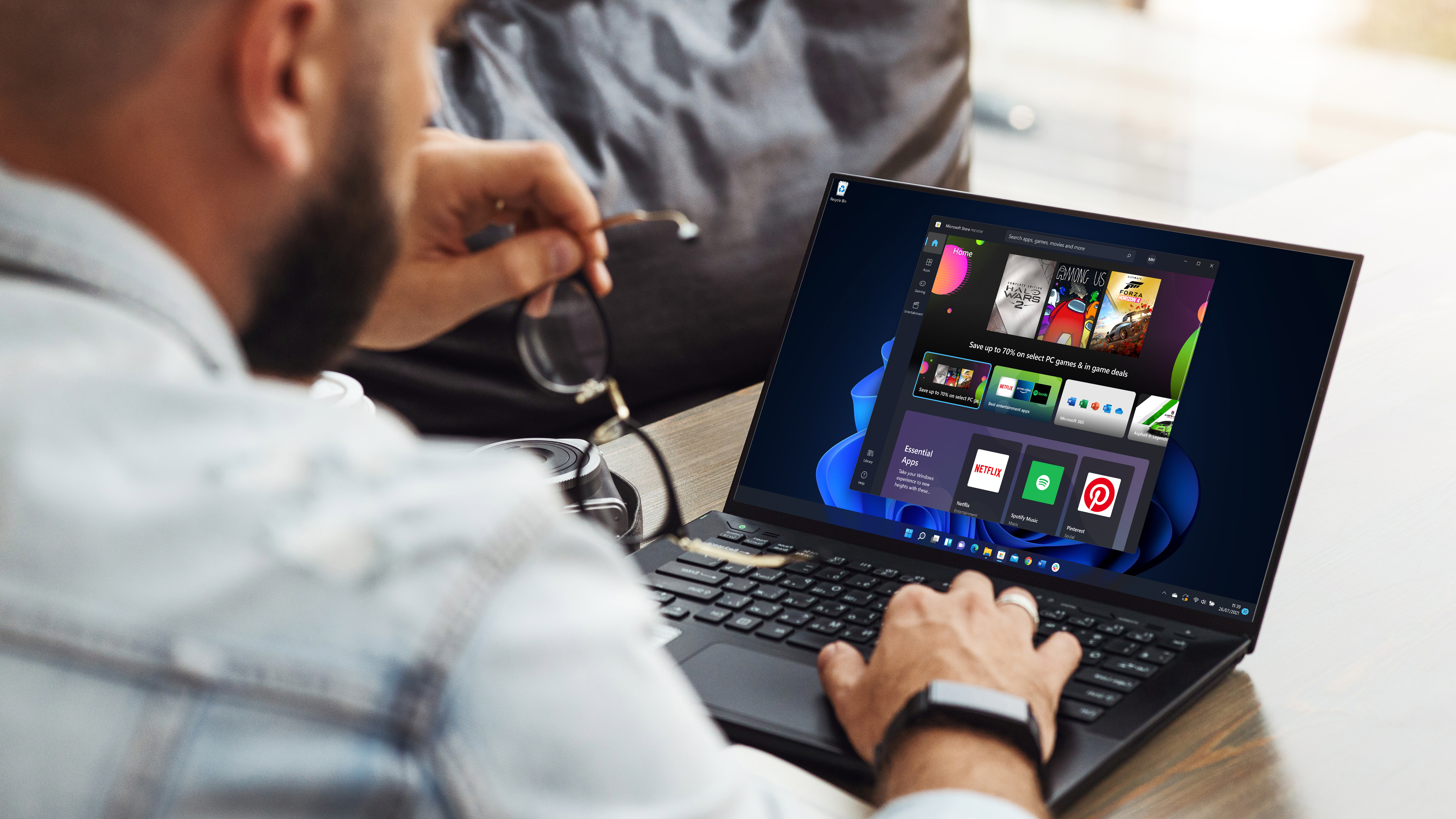 Rear view of a man who uses a laptop with the application of Microsoft Store of Windows 11 '
