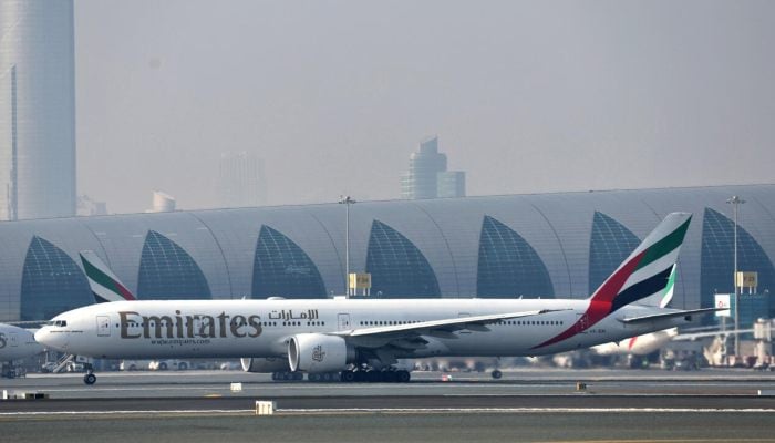 A photo taken on January 30, 2023 at Dubai airport shows the first milestone demonstration flight in a Boeing 777-300er Emirates. - AFP