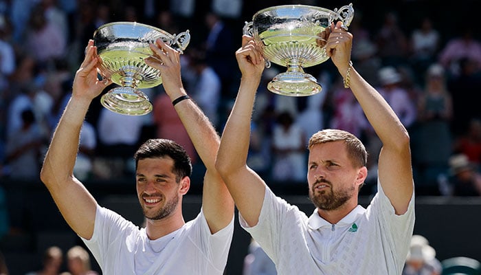Great Britain Lloyd Glaspol and Julian Cash celebrate with their trophies after winning the doubles for Wimbledon men against Australia Hijikata and Netherlands David Pel in the All England Lawn Tennis and Croquet Club, London on July 12, 2025. - Reuters.