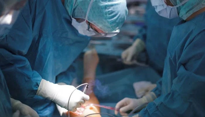 A representative image that shows doctors who perform a surgical procedure. - Reuters/file
