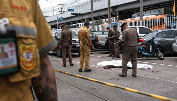 The Thai Police stopped with a covered agency while inspecting the scene after four security guards were killed in a shooting in the O Tor Kor market in Bangkok on July 28, 2025. - AFP