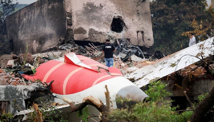 A fire officer is next to the Air India Boeing 787-8 Dreamliner plane, in Ahmedabad, India, June 13, 2025.-Reuters