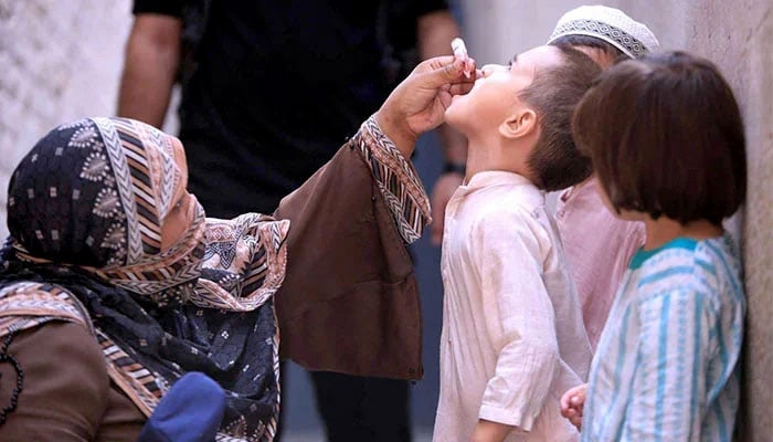A health worker who manages Polio falls to a child during the Pakistan Poly Eradication Program of 7 days 2024 in Provincial Capital on September 9, 2024.-Epp