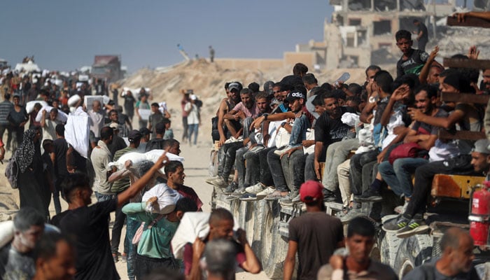 The Palestinians carry help supplies that entered Gaza through Israel, in Beit Lahia, Northern Gaza Strip, August 2, 2025. - Reuters